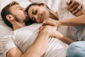 Woman cuddling younger man